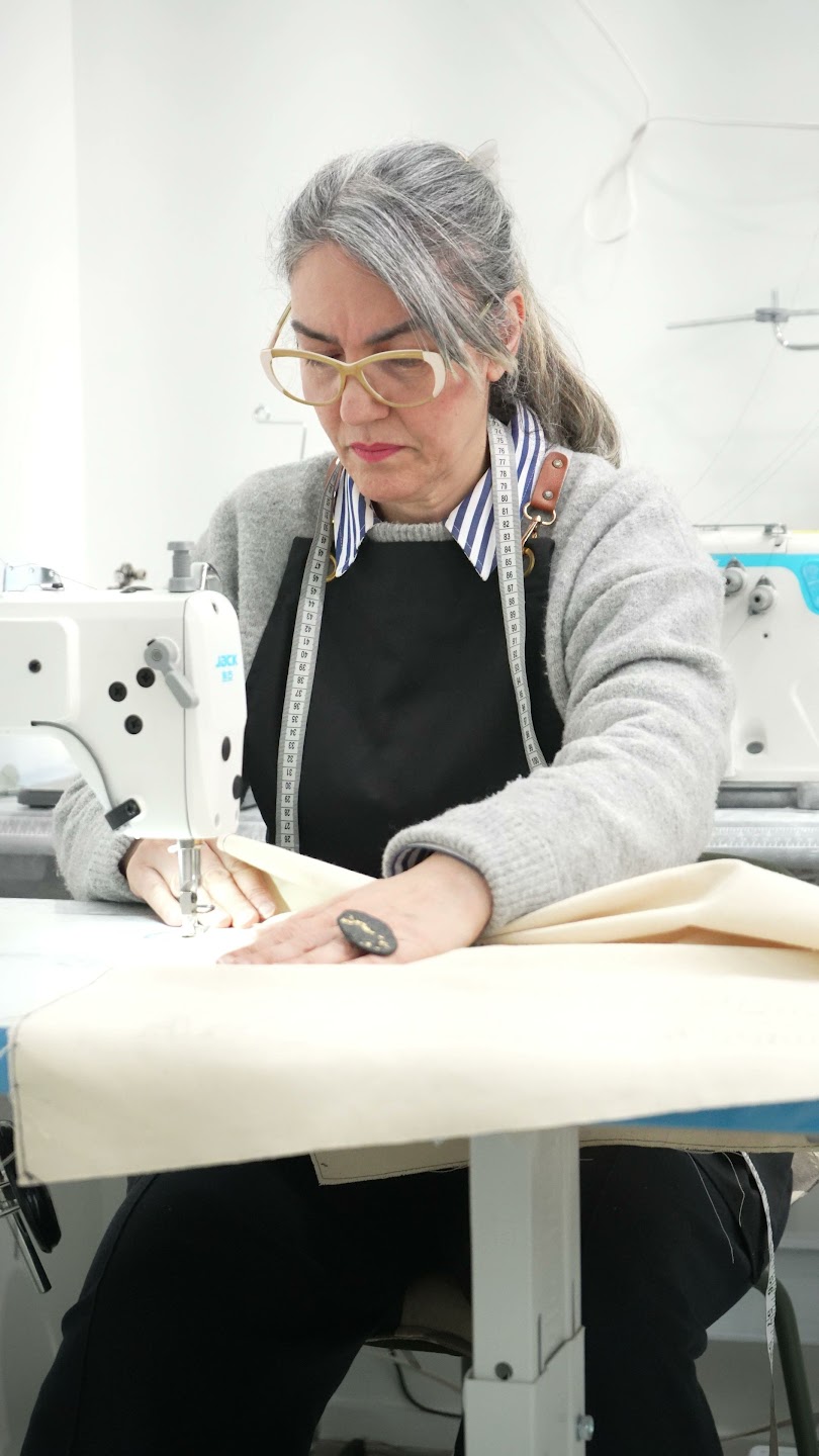 Fatima sewing fabric at her industrial machine